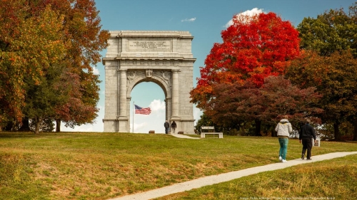 outdoor image of vibrant trees and a large archway
