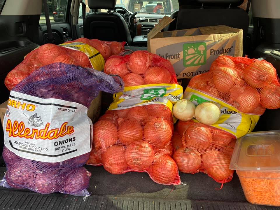 bags of onions and potatoes in the back of a van