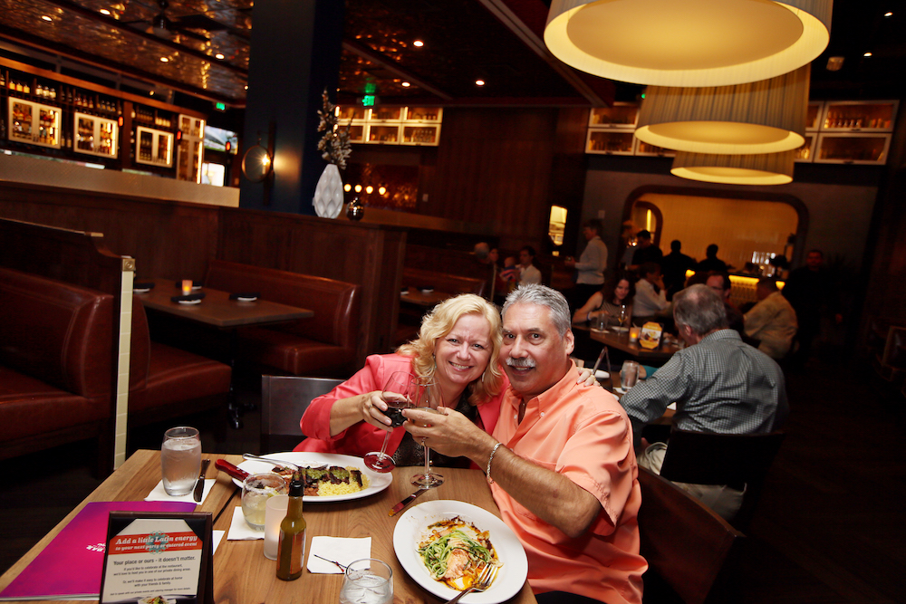 two people hugging for photo in restaurant