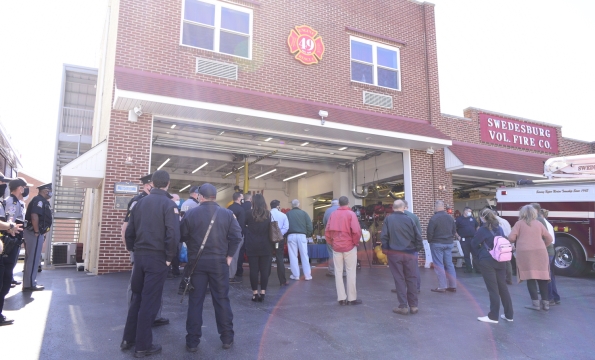 crowd of people standing outside a fire house