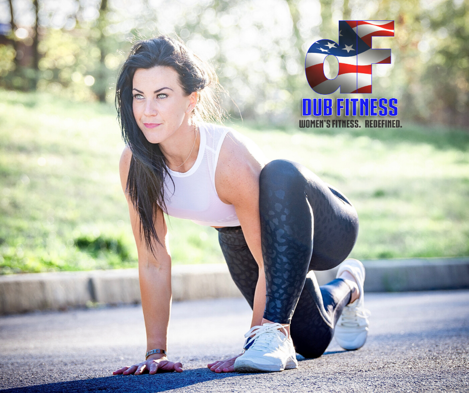 Woman crouched down in sprinting position on the street