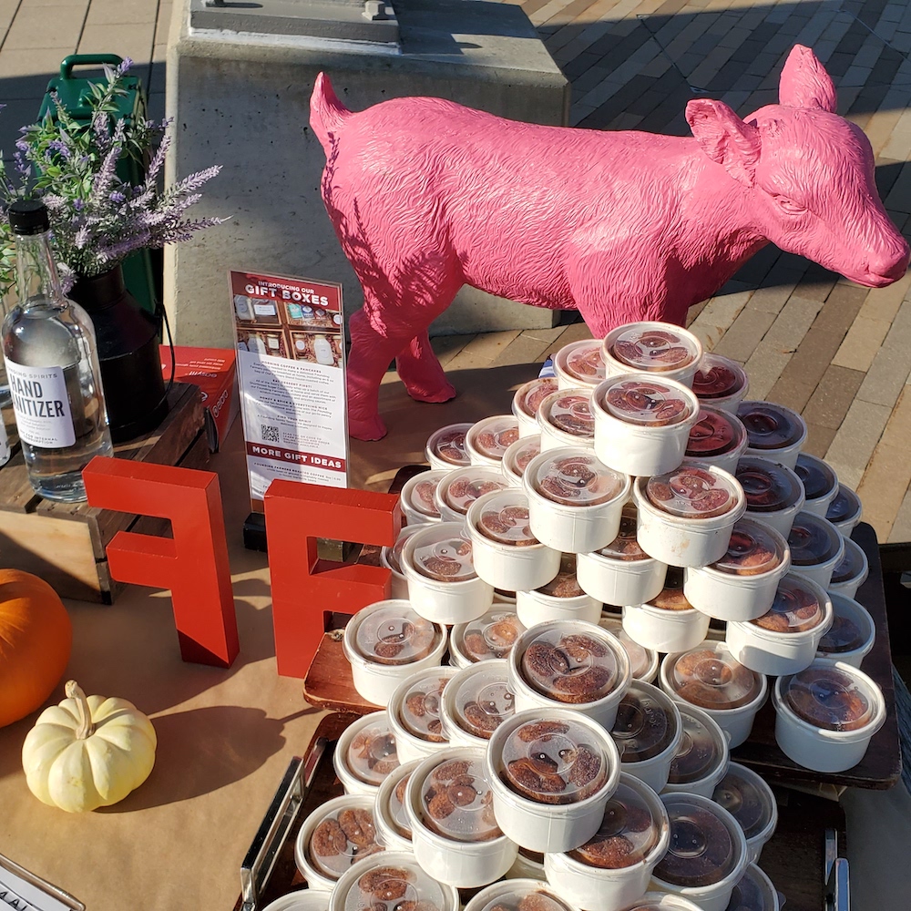 Image of a table featuringa pink lamb and a pile of containers with food inside