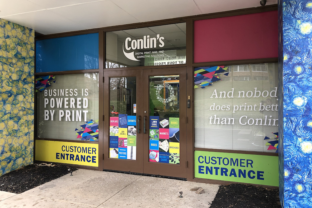 Glass font of building with colorful signage