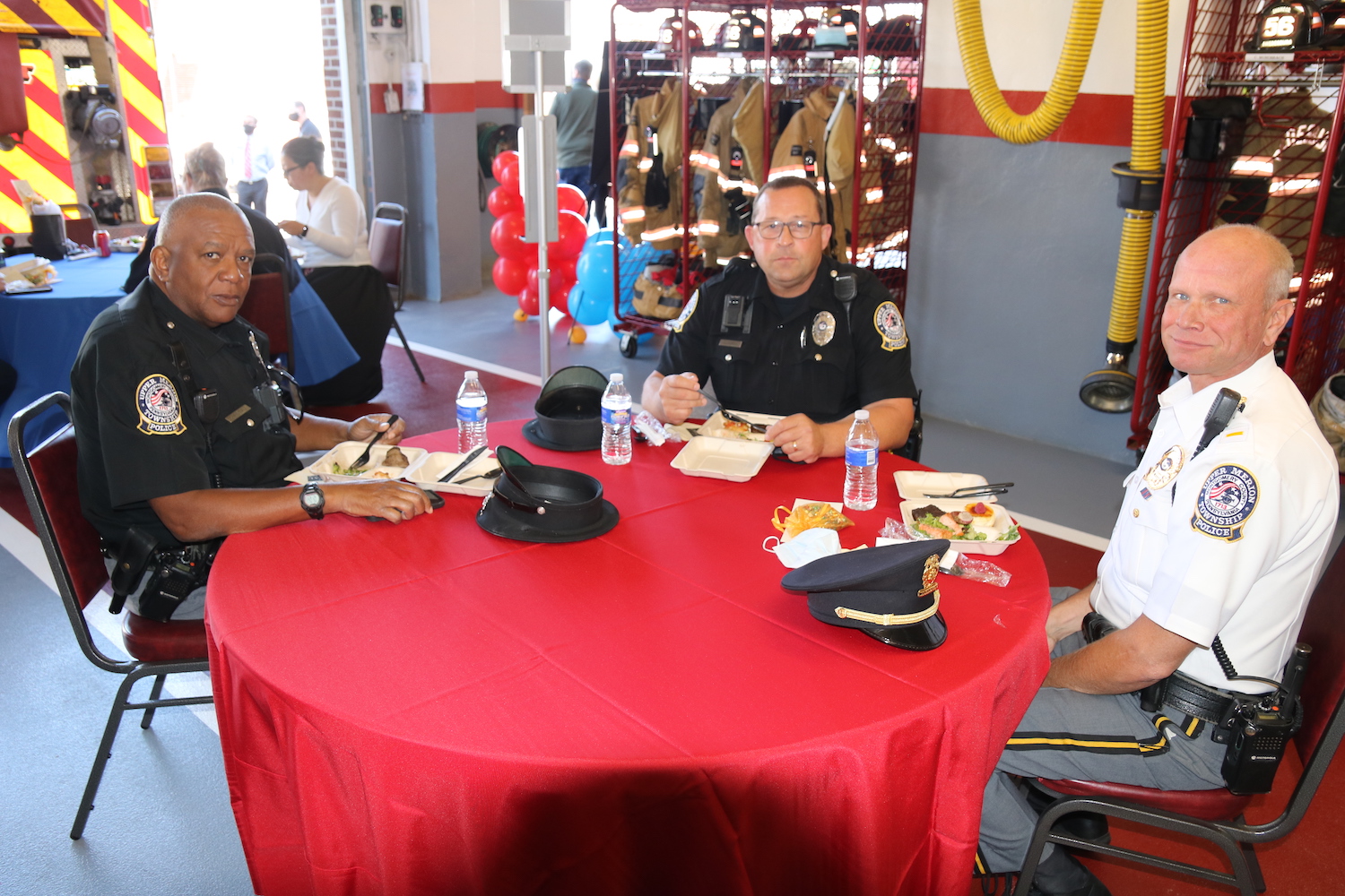three police officers sitting at a table smiling