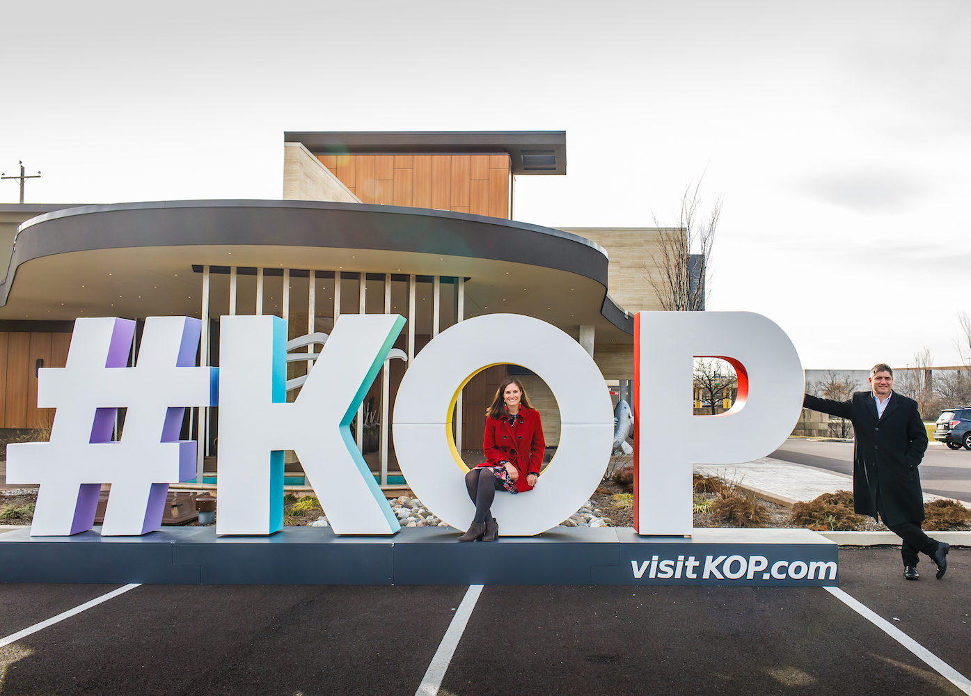 Man and woman posing by giant #KOP letters