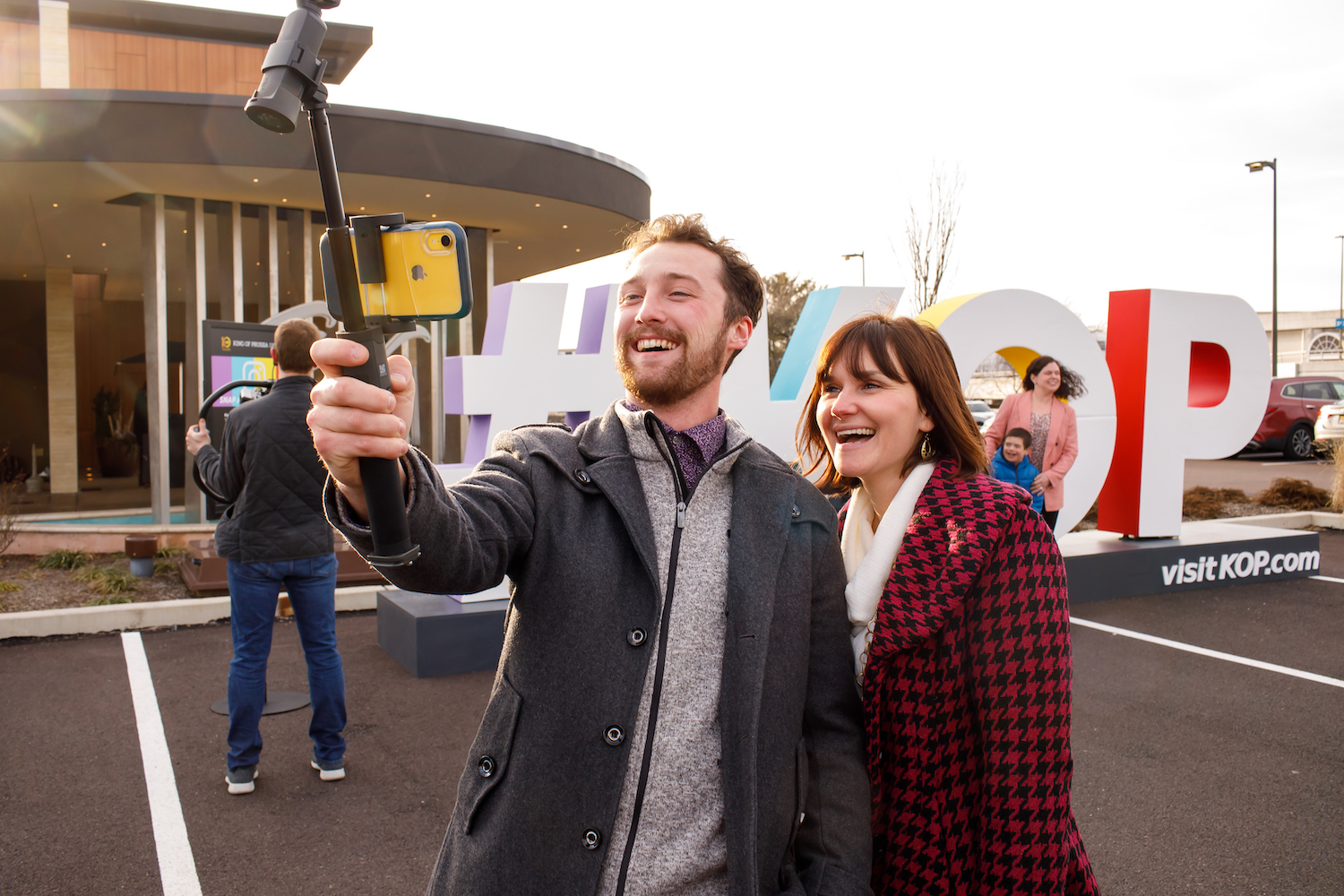 A man and woman taking a selfie in front of giant letters