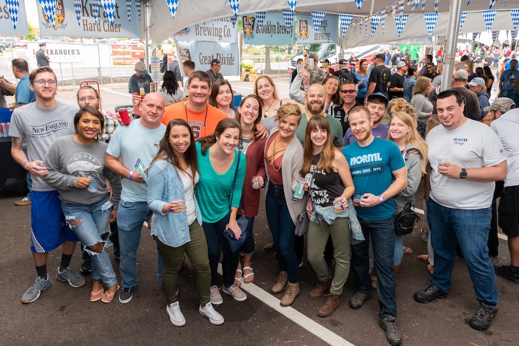 large group of people smiling for photo at a beer fest