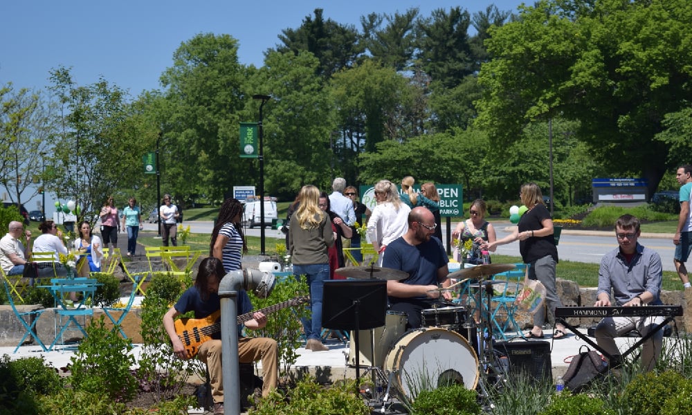 band playing outside amoungst a group of people