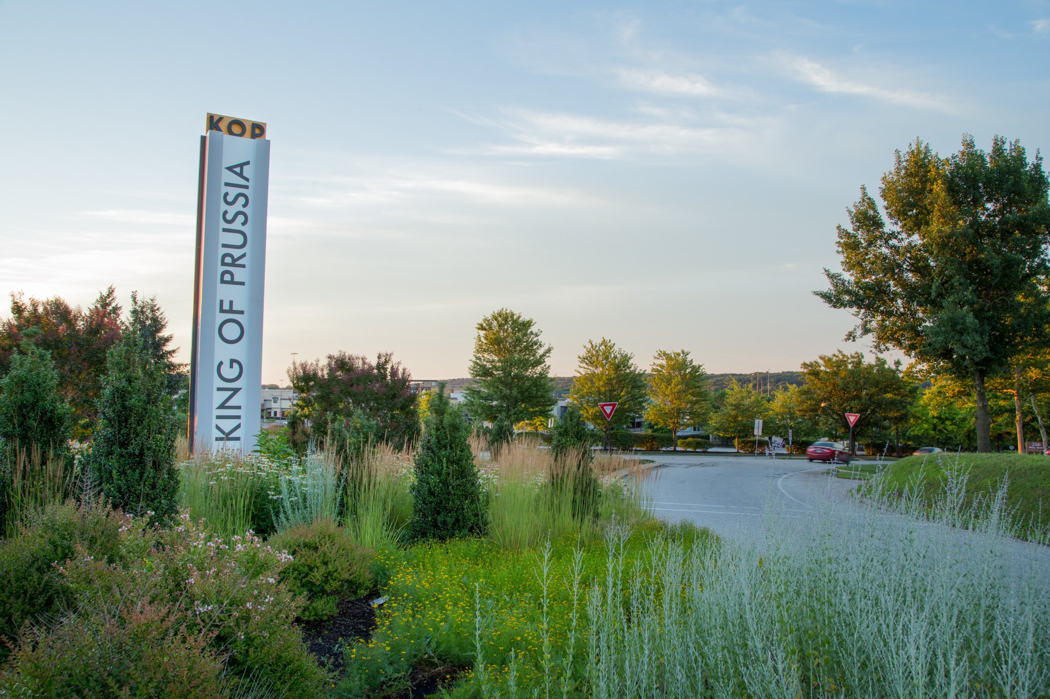 Large vertical King of Prussia sign surrounded by foliage