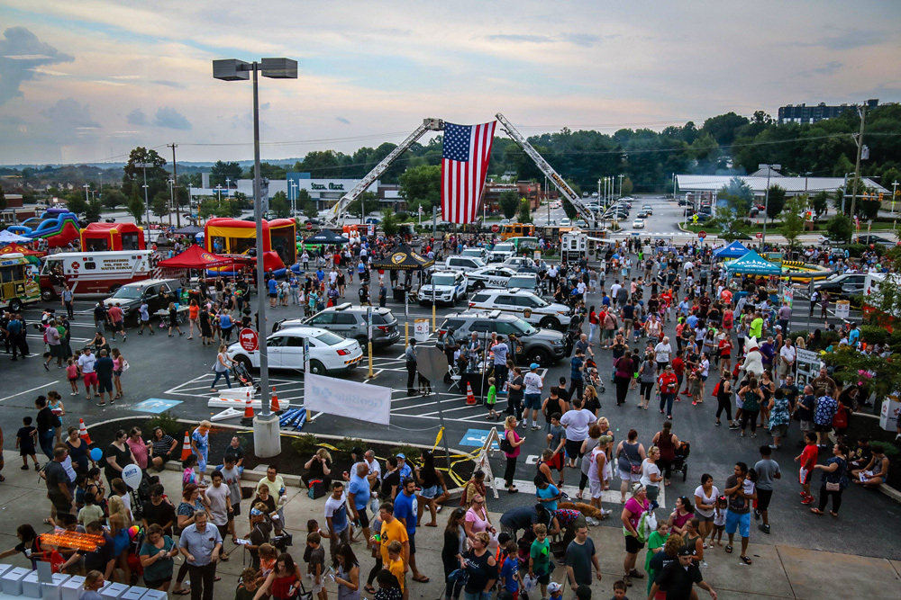 aerial view of people gathered and various stalls with an American flag