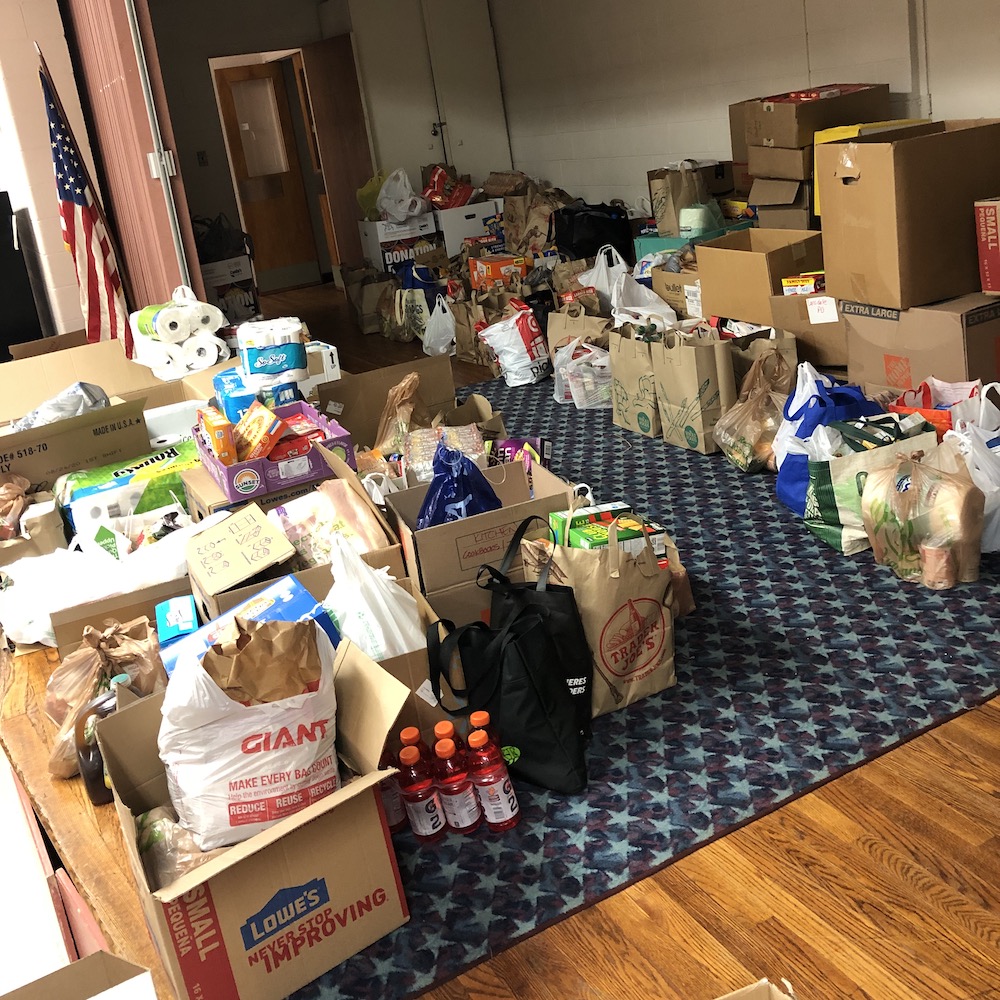 Piles of bags and boxes full of food and goods