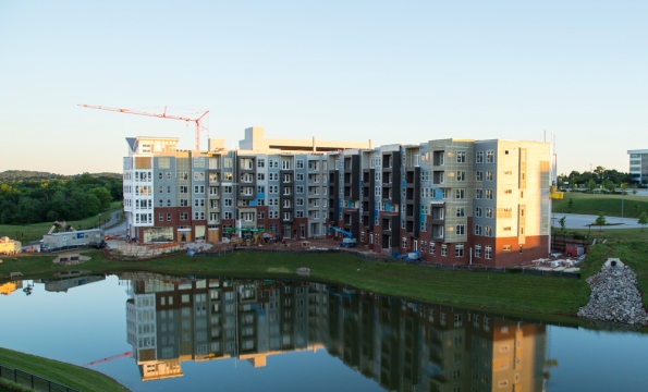 apartment complex being built next to a lake