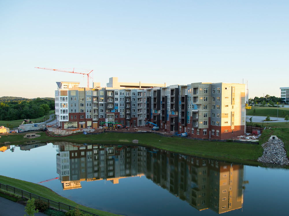 apartment complex being built next to a lake