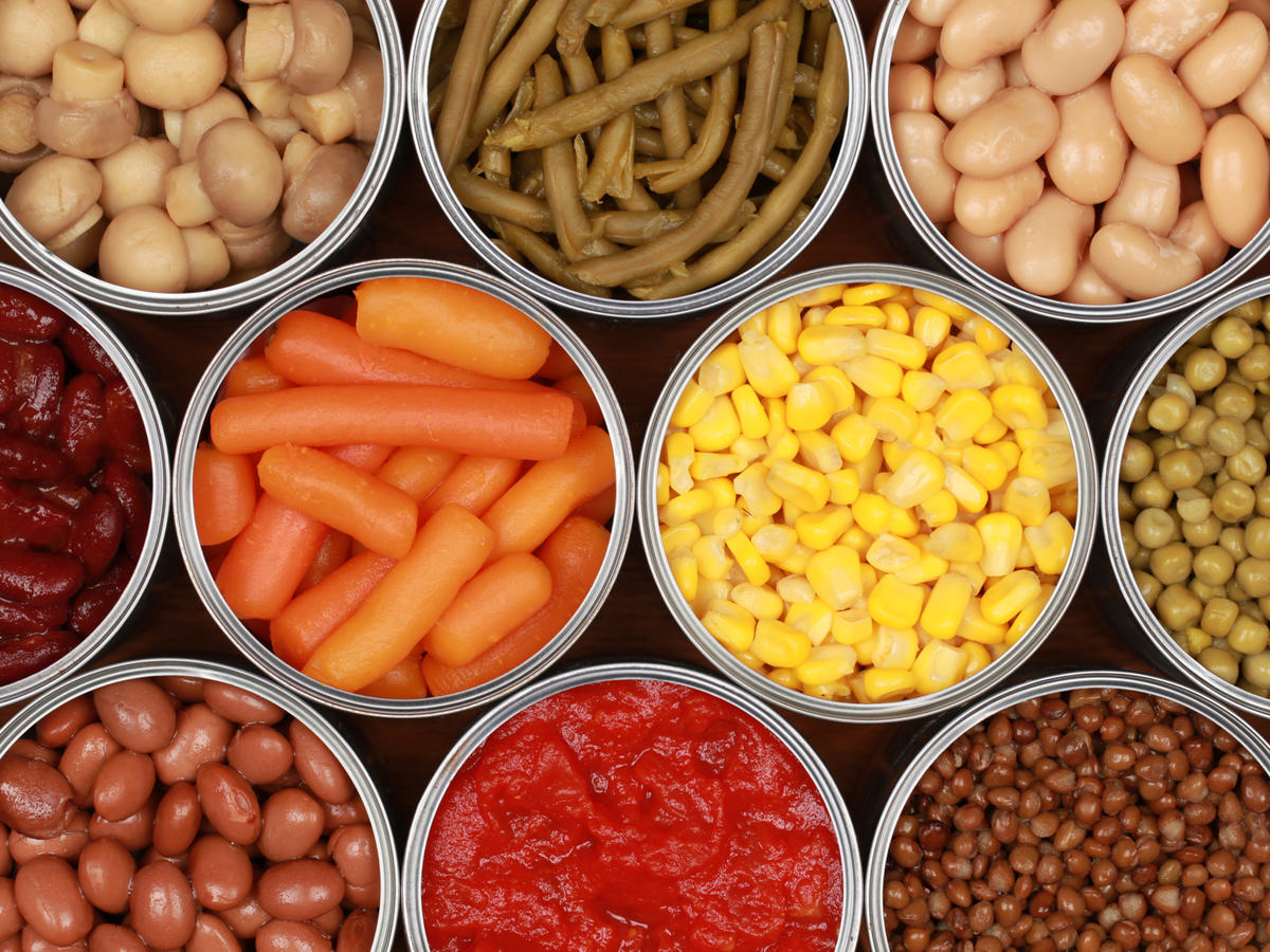 aerial view of open cans containing different vegetables