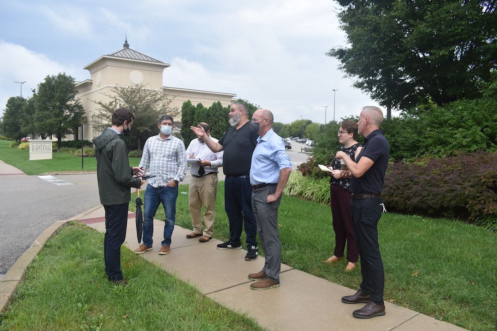 group of people standing outdoors talking