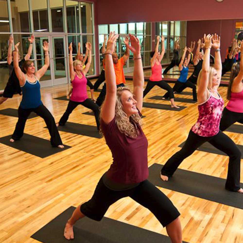 group of people doing exercises in gym