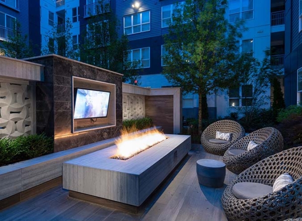 outdoor seating with fire pit and television