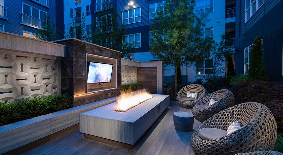outdoor seating with fire pit and television
