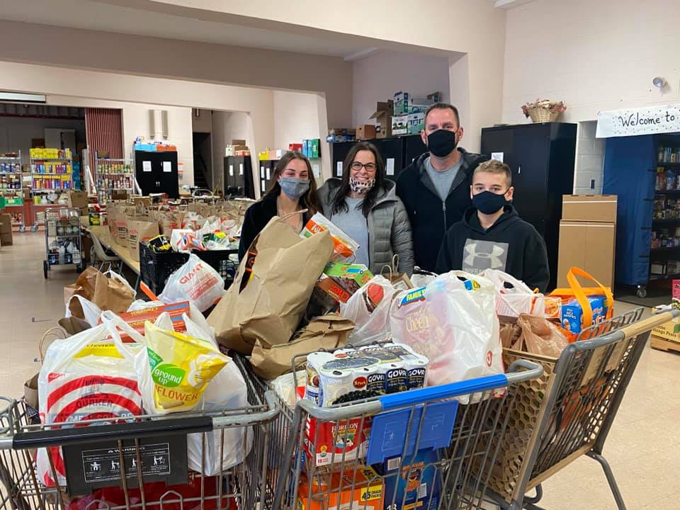 family with shopping carts full of food