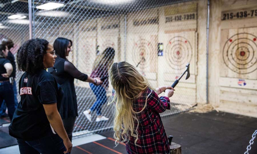 group of people axe throwing