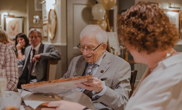 senior citizen opening gift
