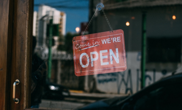 open sign hanging in a window