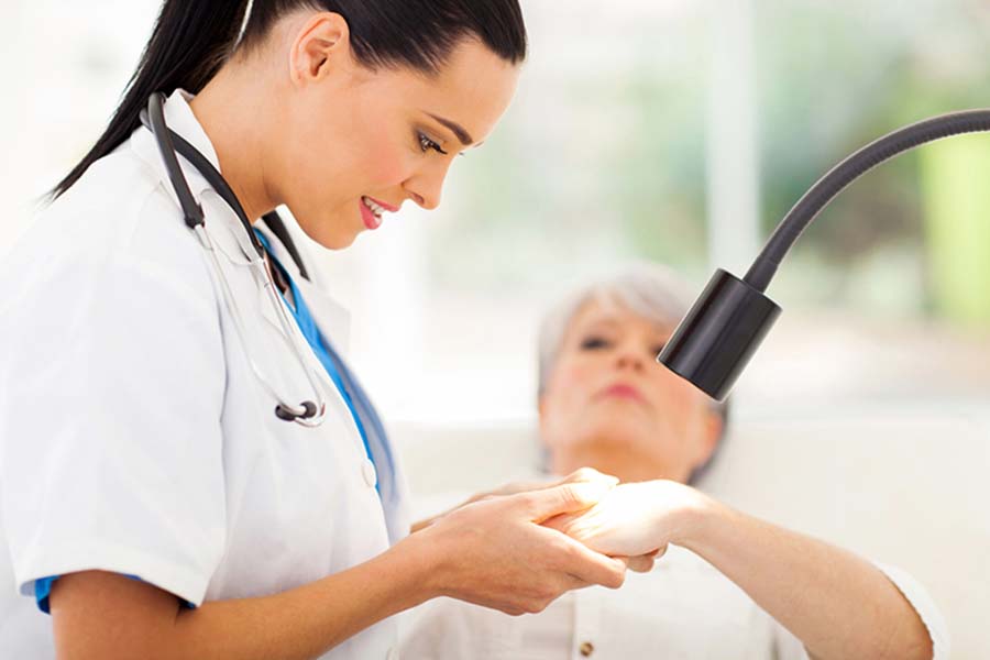 dermatologist examining patient's hand