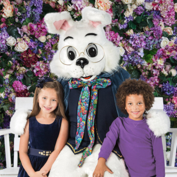 giant bunny with two children standing by their side