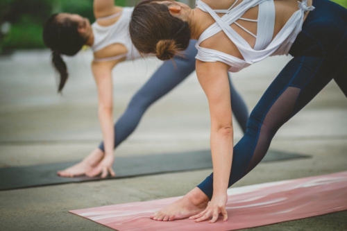 two people in a yoga post outdoors