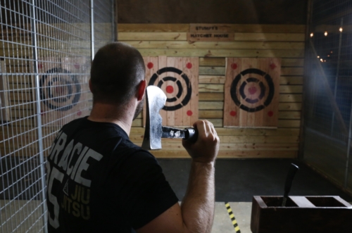 Person holding an axe and looking towards a target