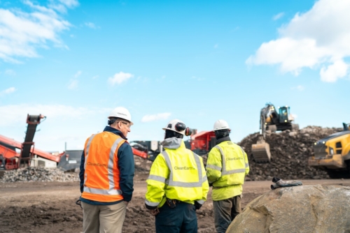three people standing at a construction site