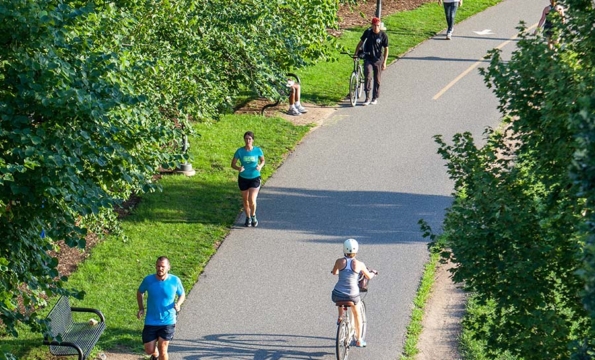 aerial view of a wide trail with people running and bike riding