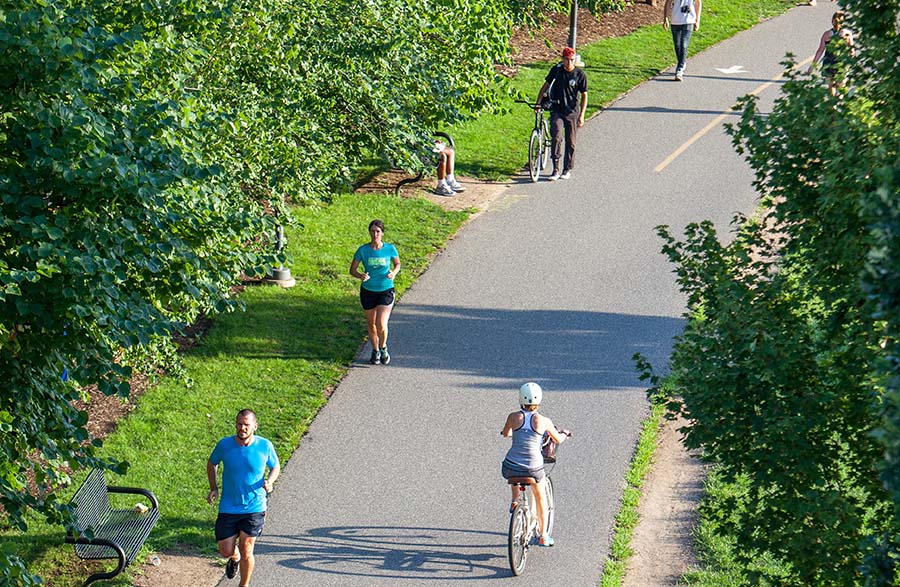 aerial view of a wide trail with people running and bike riding