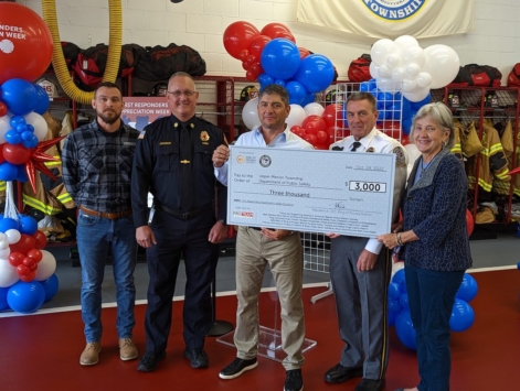 group of people holding large check