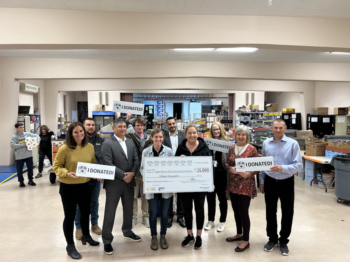 group of people holding a large check