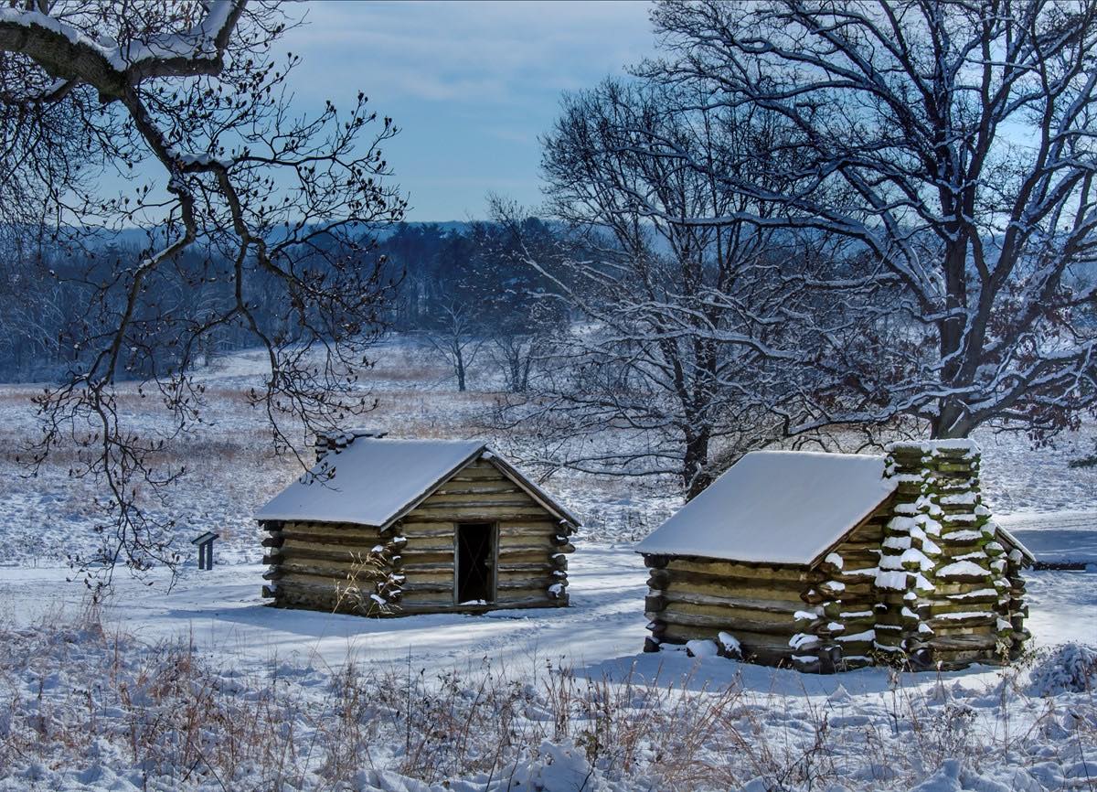 huts in valley forge park covered in snow