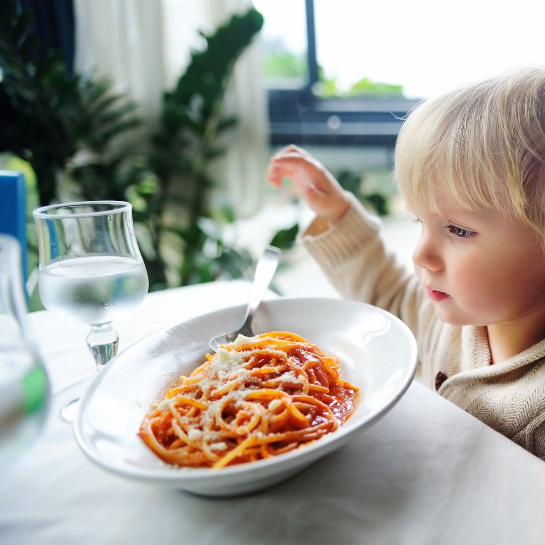 kid eating pasta