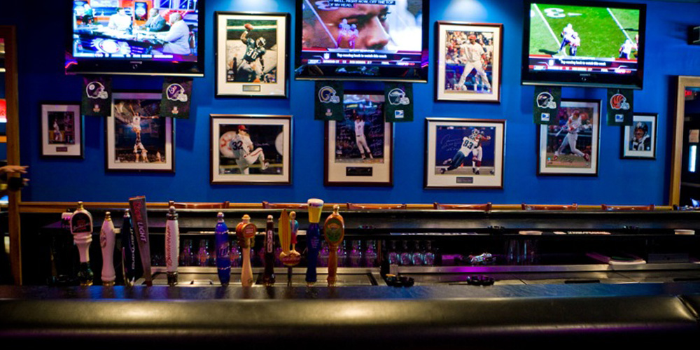 a wall filled with frames sports images