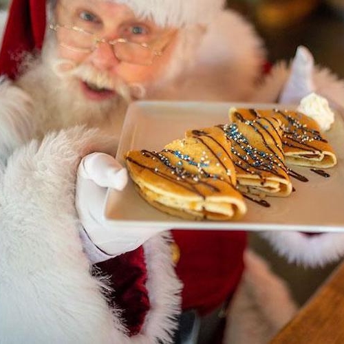 santa holding out a plate of pancakes