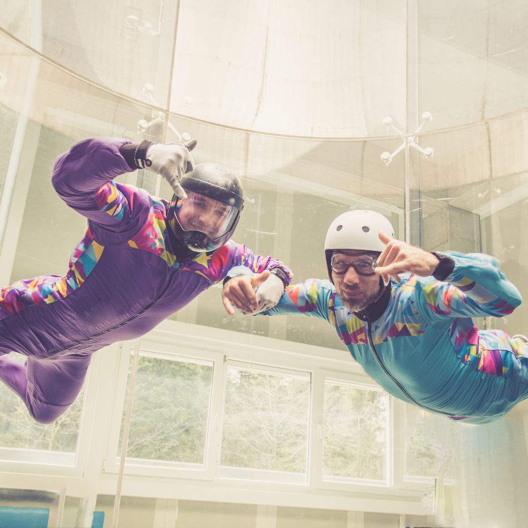 two people floating in an ifly air chamber