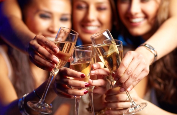 several women clinking champagne flutes