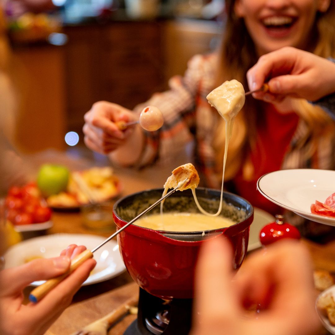 people smiling and dipping fondue