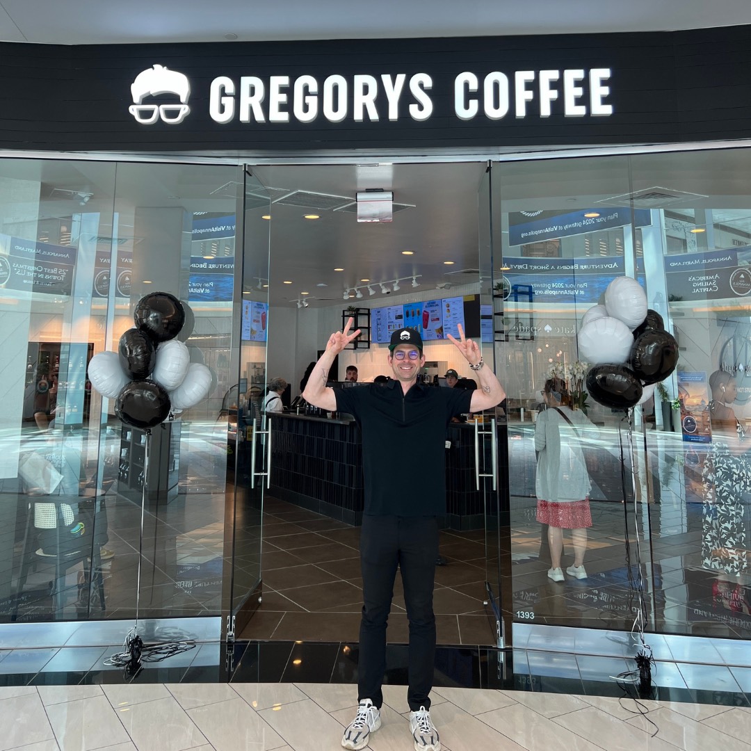 Person standing in front of Grogorys Coffee storefront