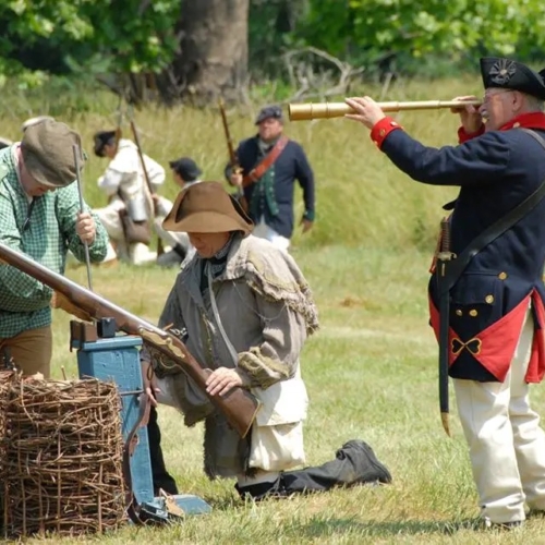 people dressed in continental army clothing outdoors