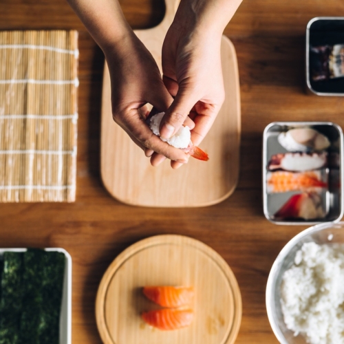 aerial view of person making a sushi roll