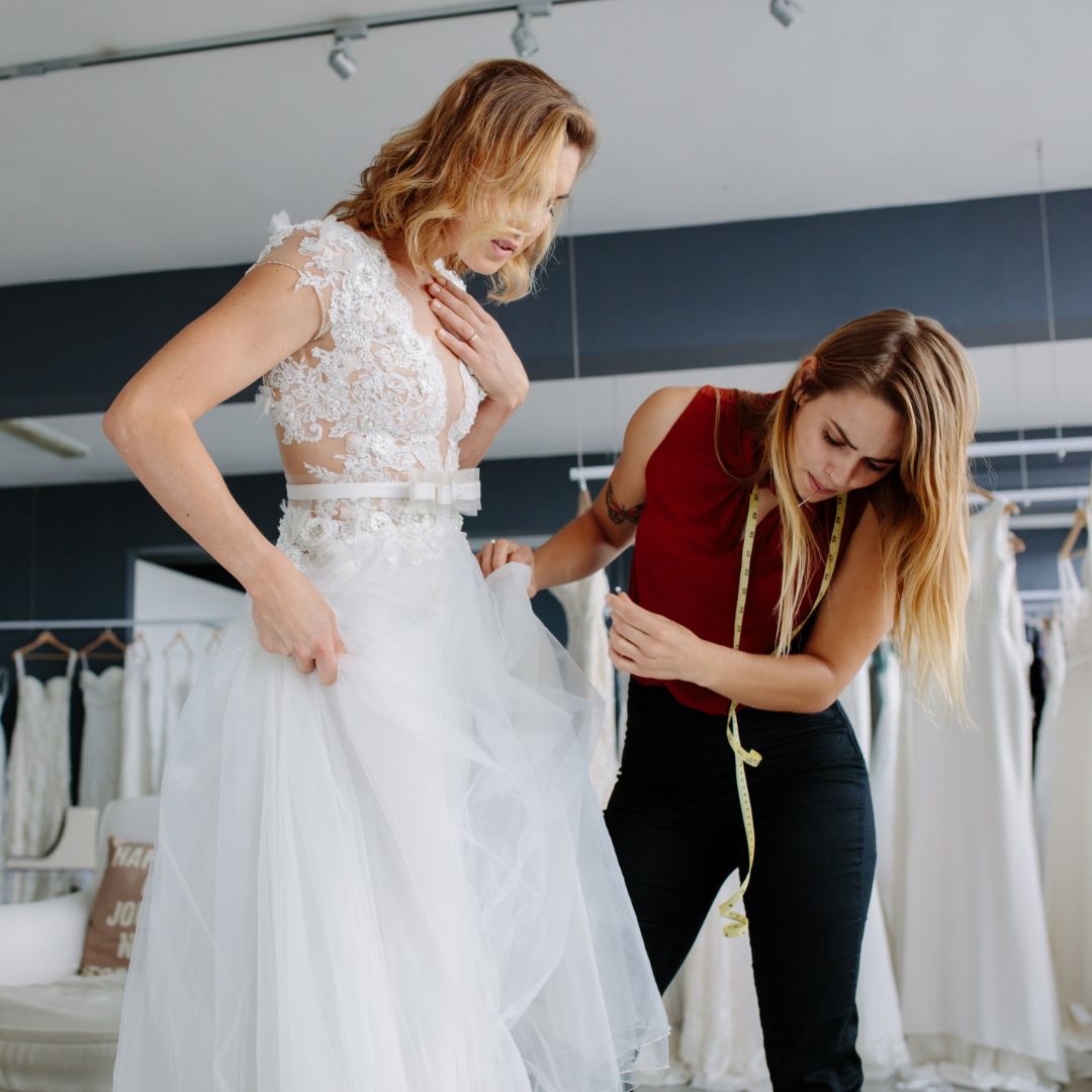 person being fitted in a wedding dress