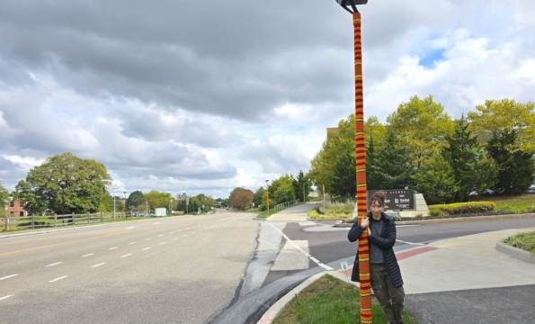 person standing by a knitted light pole