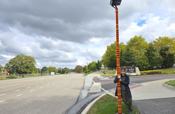 person standing by a knitted light pole