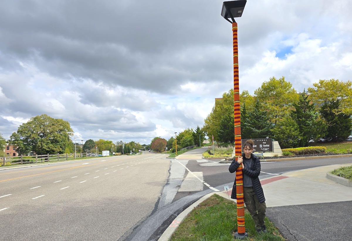 person standing by a knitted light pole