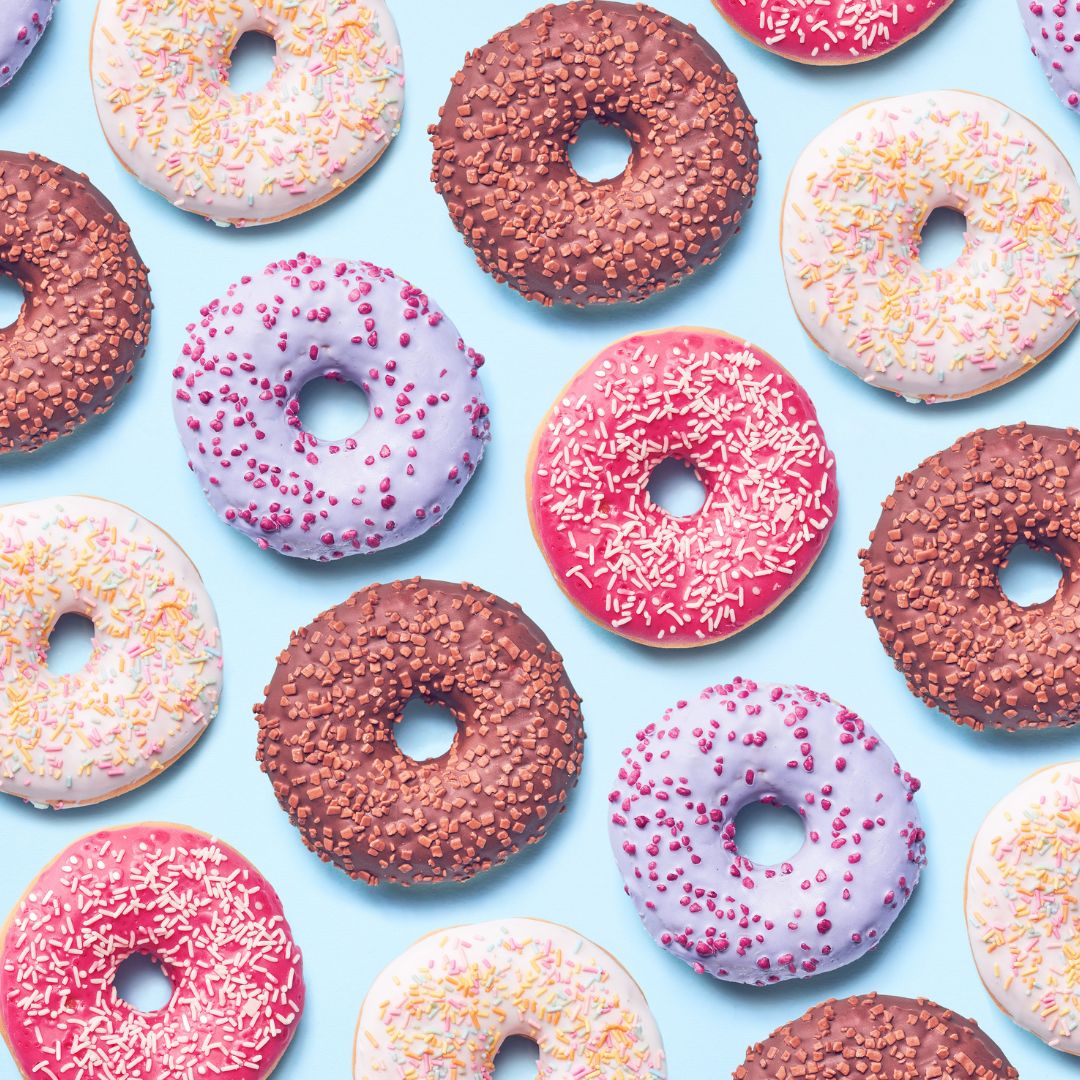 a variety of donuts on a blue surface